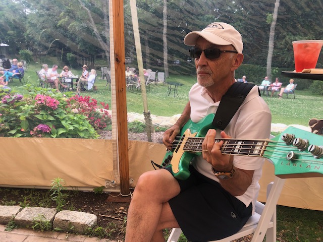 dave sitting playing blue guitar